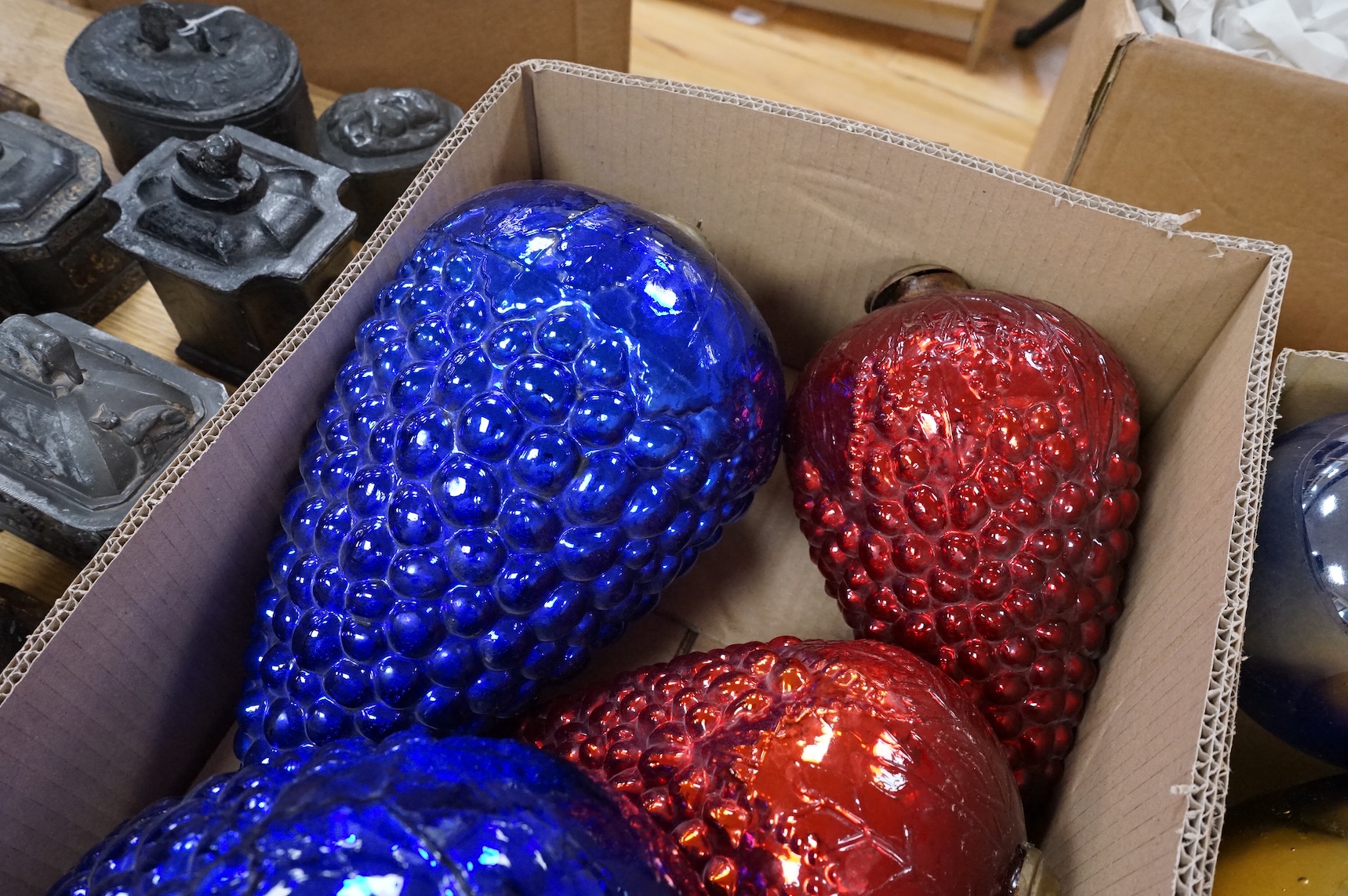 A collection of coloured circular and grape shaped glass witches balls and decorations, largest grape decoration 40cm in length